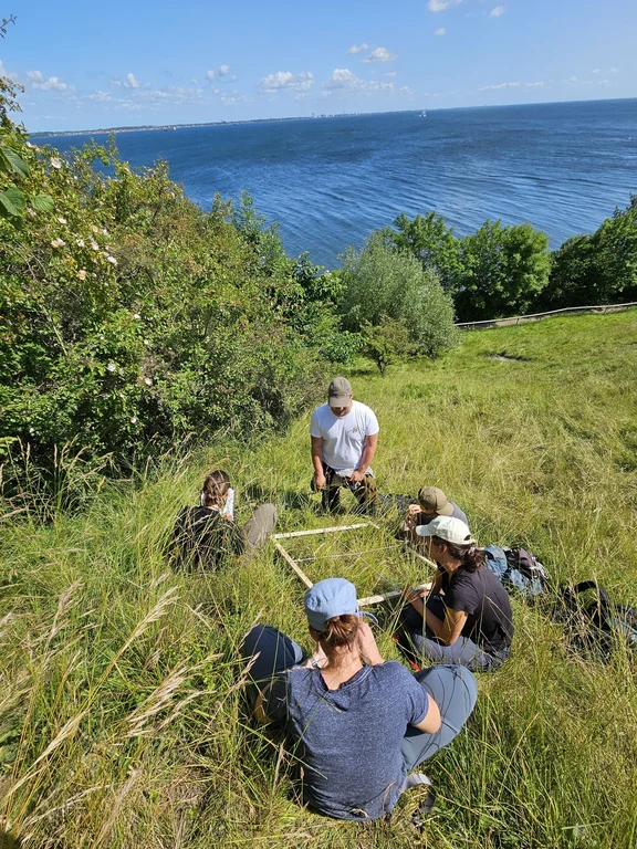 A group of masters students in the field